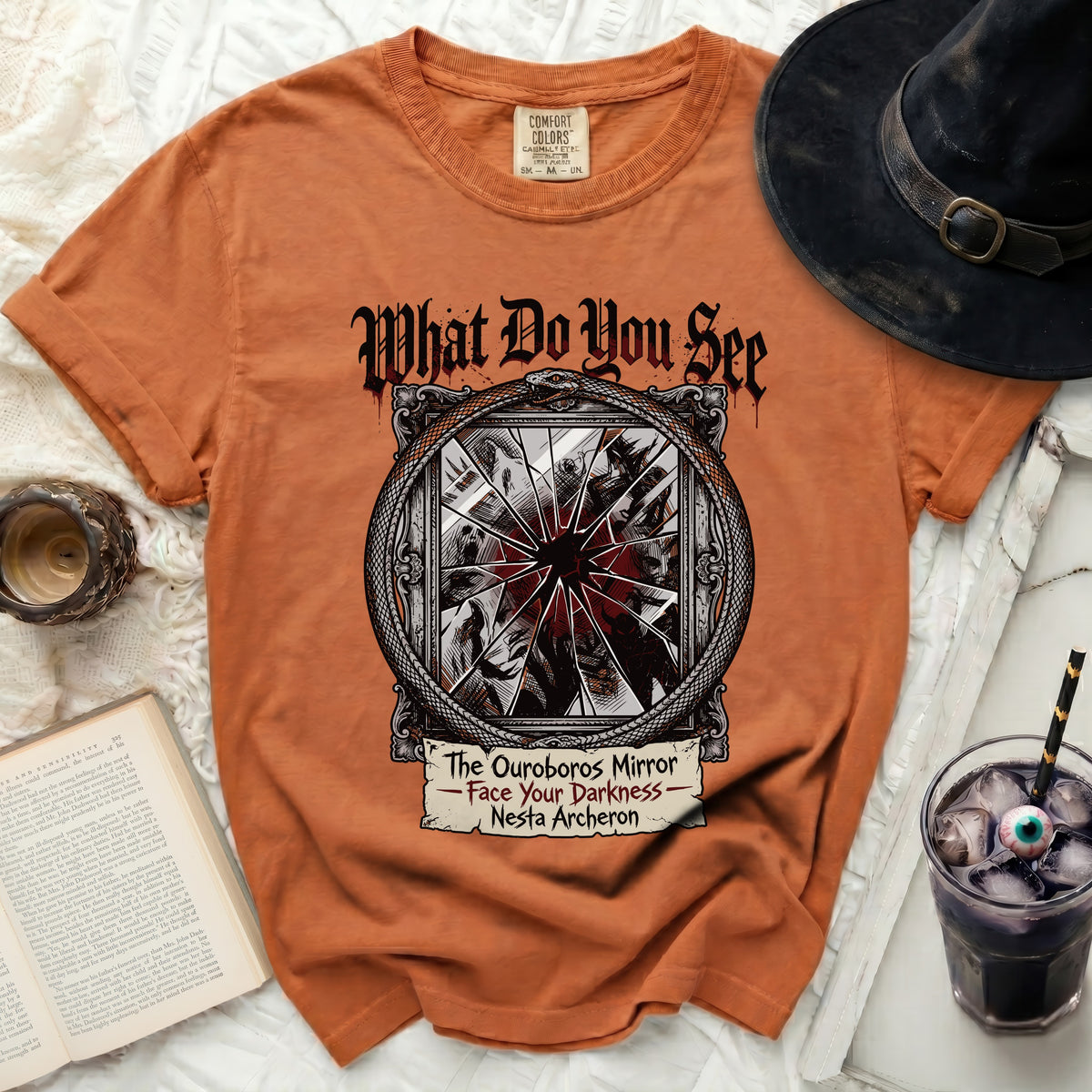 Orange t-shirt with "The Ouroboros Mirror - Face Your Darkness - Nesta Archeron" graphic.