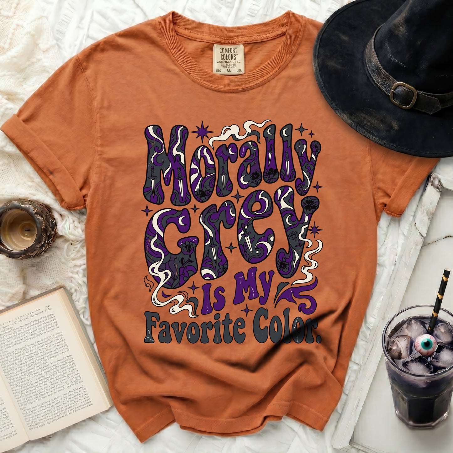 Orange t-shirt with purple, gray, and white text reading "Morally Grey is My Favorite Color."