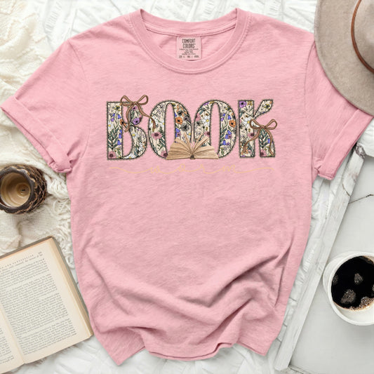 Pink t-shirt with "BOOK" in floral letters and an open book graphic.