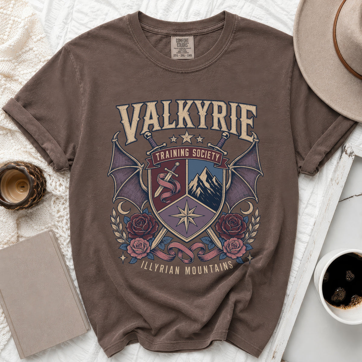 Brown t-shirt with Valkyrie Training Society shield and Illyrian Mountains text.