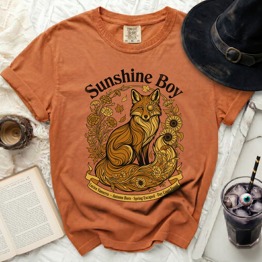 Orange t-shirt with "Sunshine Boy" text and a fox surrounded by flowers.