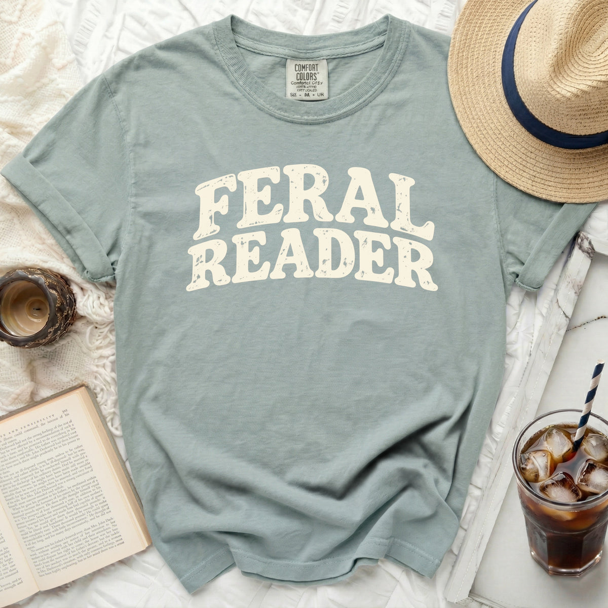 Dusty blue t-shirt with distressed "Feral Reader" text