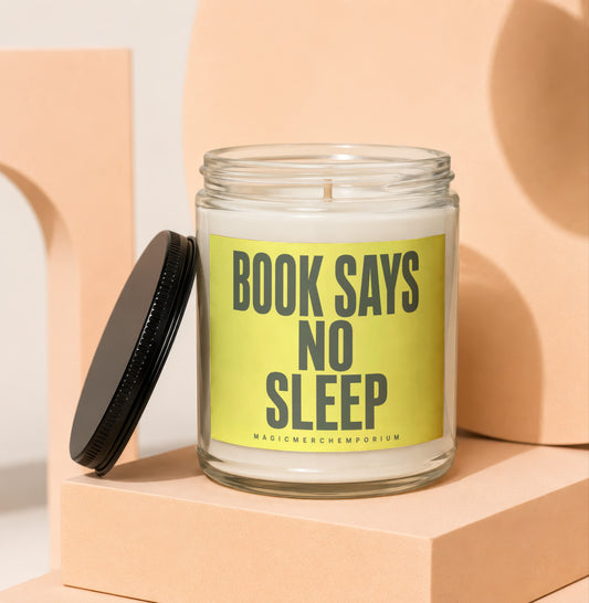 Glass candle with yellow label reading "BOOK SAYS NO SLEEP".