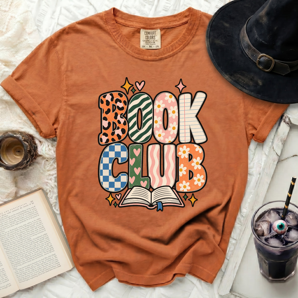 Orange t-shirt with "BOOK CLUB" graphic and an open book illustration.