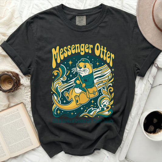 Dark t-shirt with "Messenger Otter" graphic and crescent moon delivery service text.