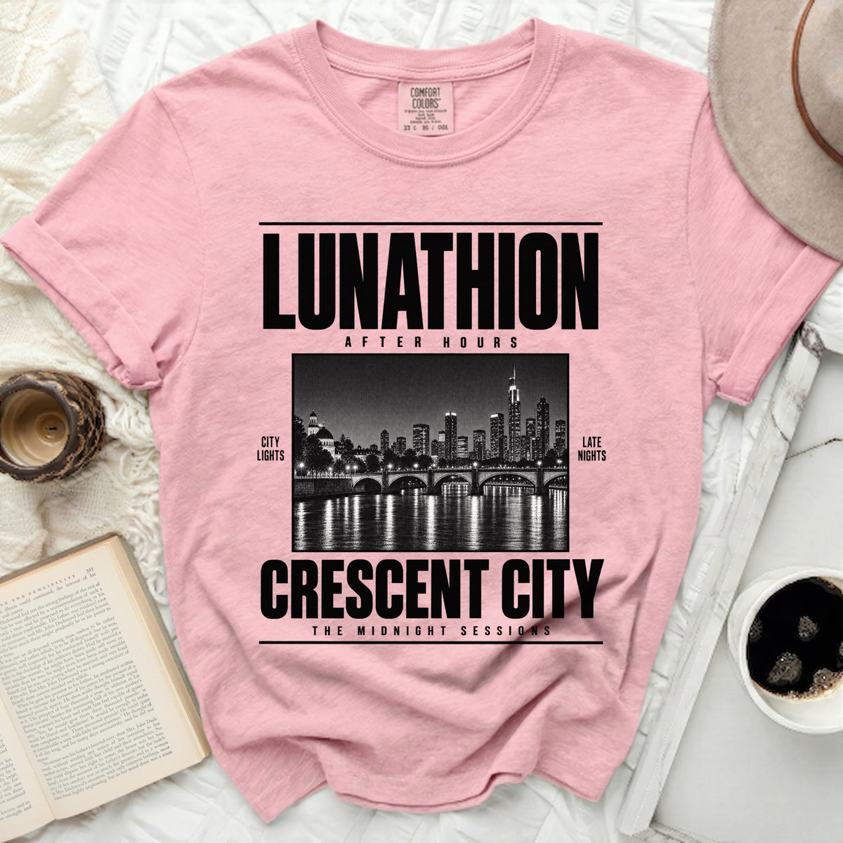 Pink t-shirt with "LUNATHION AFTER HOURS CRESCENT CITY THE MIDNIGHT SESSIONS" text.