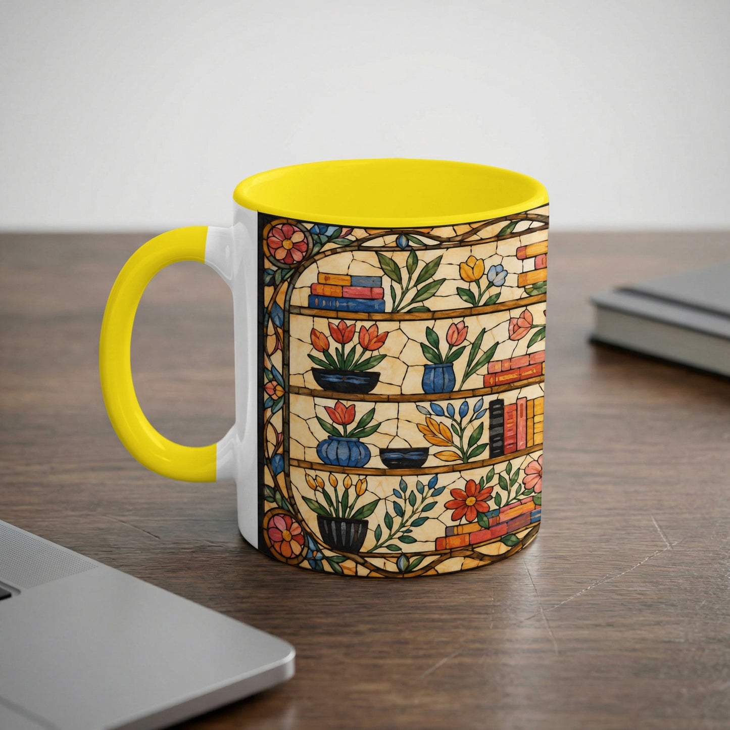 Yellow mug with a stained-glass design of books and flowers on shelves.