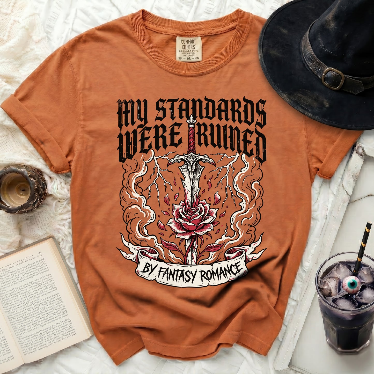 Orange t-shirt with "My Standards Were Ruined By Fantasy Romance" graphic.