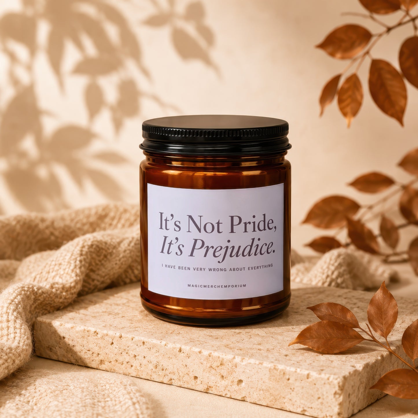 Candle with label "It's Not Pride, It's Prejudice." on textured surface.
