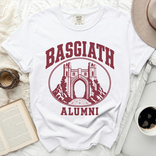 A white t-shirt featuring a maroon graphic of a stone archway, surrounded by the text Basgiath Alumni.