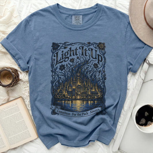 Blue t-shirt with "Light It Up" text and city skyline design.
