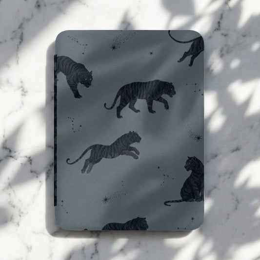 Dark gray cover with a repeating pattern of black tigers and constellations.