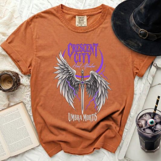 Orange t-shirt with "Crescent City Hunt Athalar Umbra Mortis" and winged sword graphic.