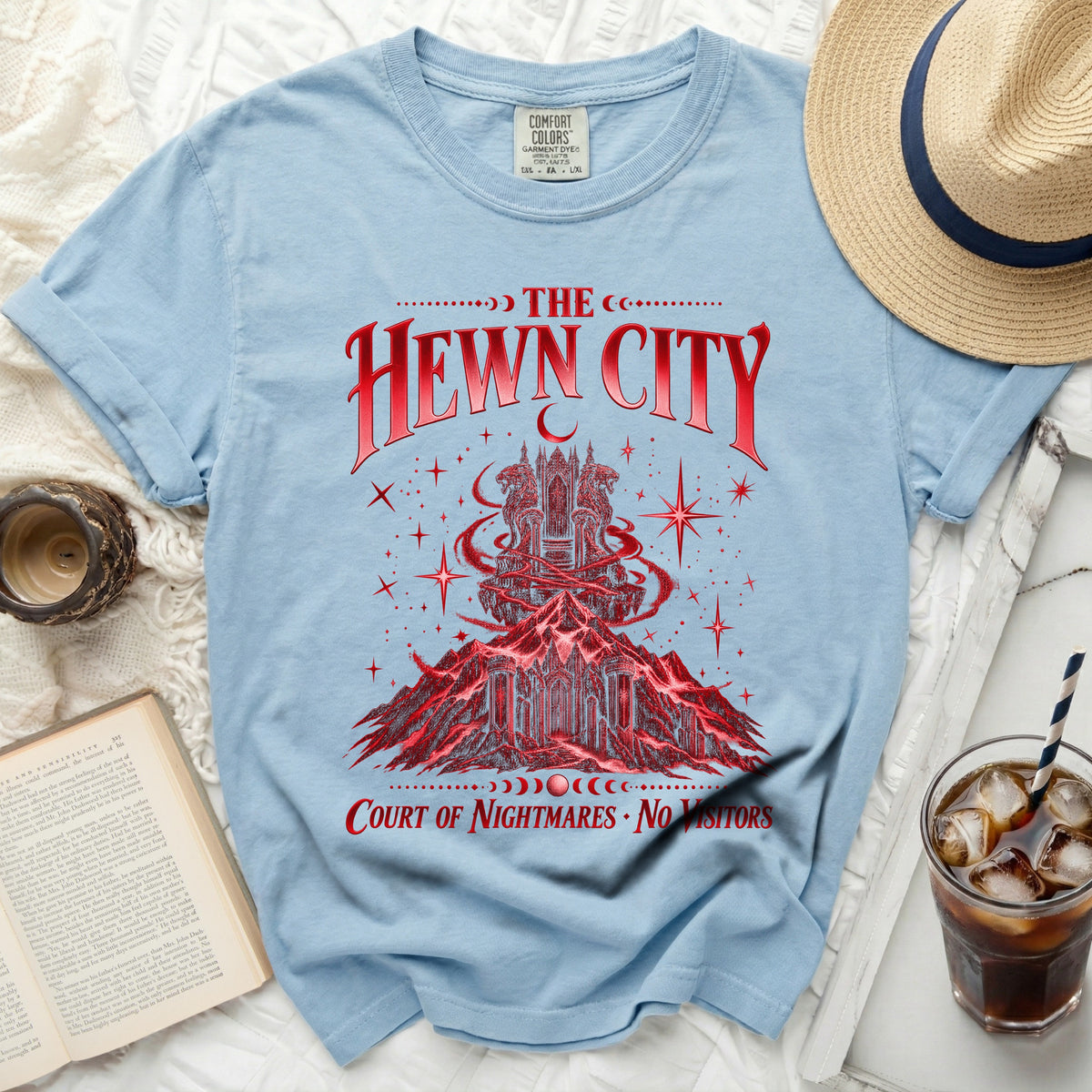 Light blue t-shirt with red graphic of a castle on a mountain and "THE HEWN CITY COURT OF NIGHTMARES • NO VISITORS" text.