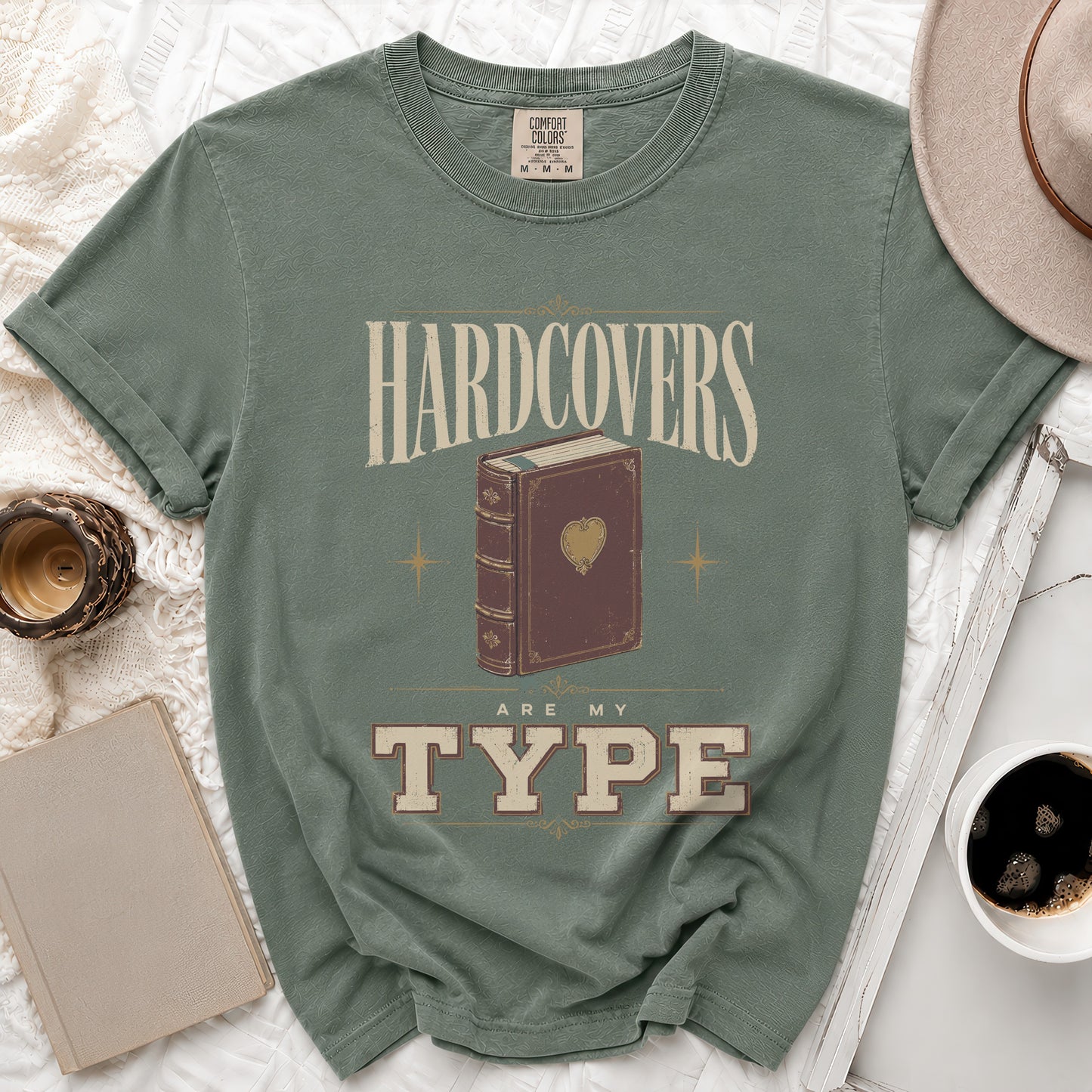 Green t-shirt with "Hardcovers are my type" and a book design.