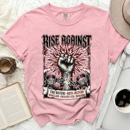 Pink t-shirt with "Rise Against" text, clenched fist, and chain graphic.