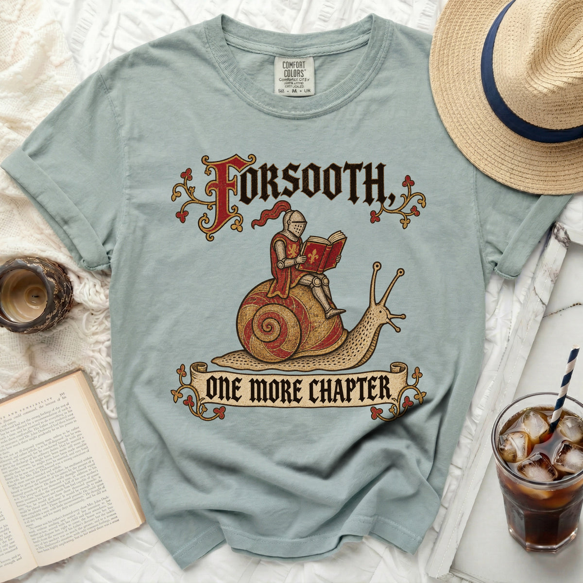 Light blue t-shirt with knight on snail graphic and text "FORSOOTH, ONE MORE CHAPTER".
