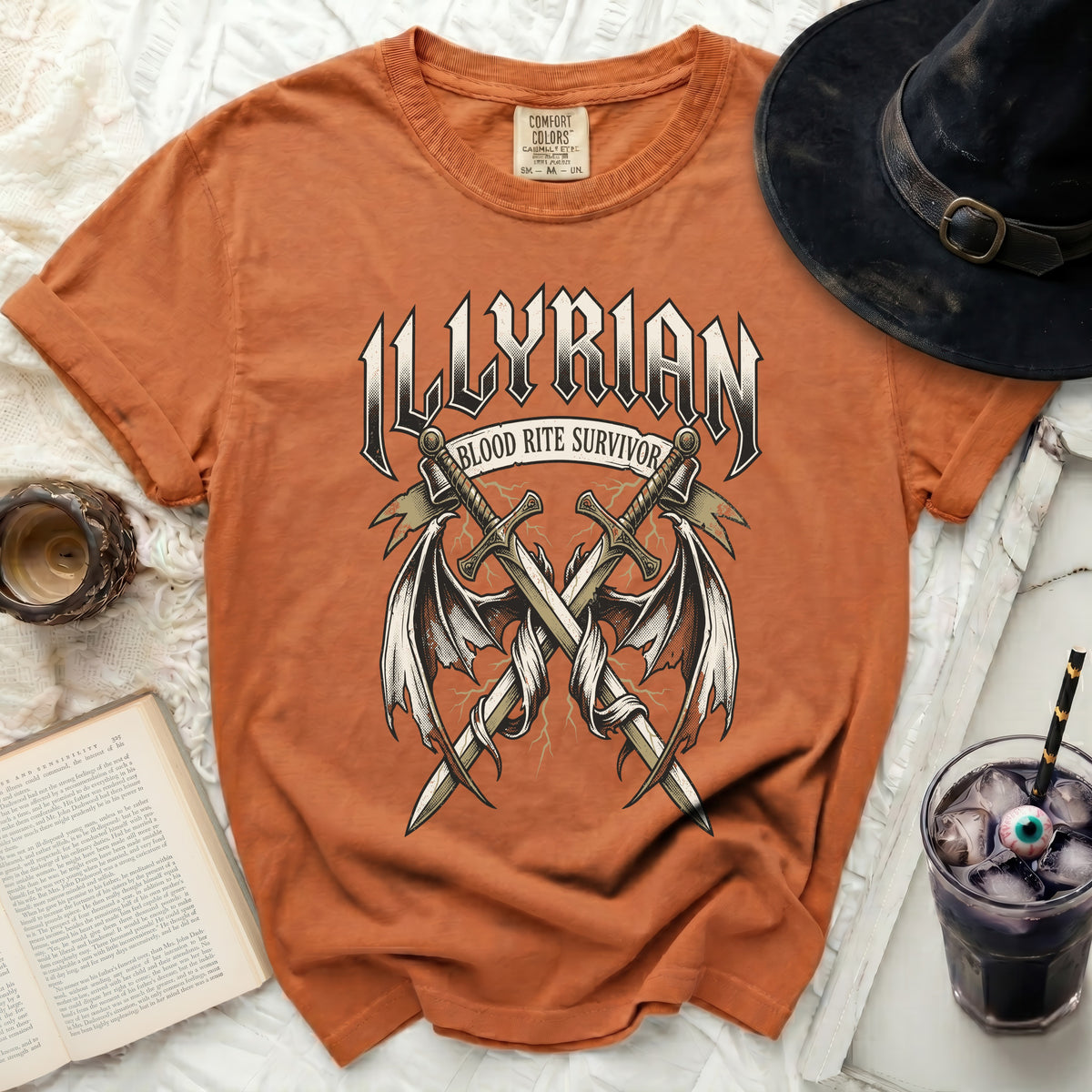 Orange t-shirt with "Illyrian Blood Rite Survivor" graphic featuring crossed swords and wings.
