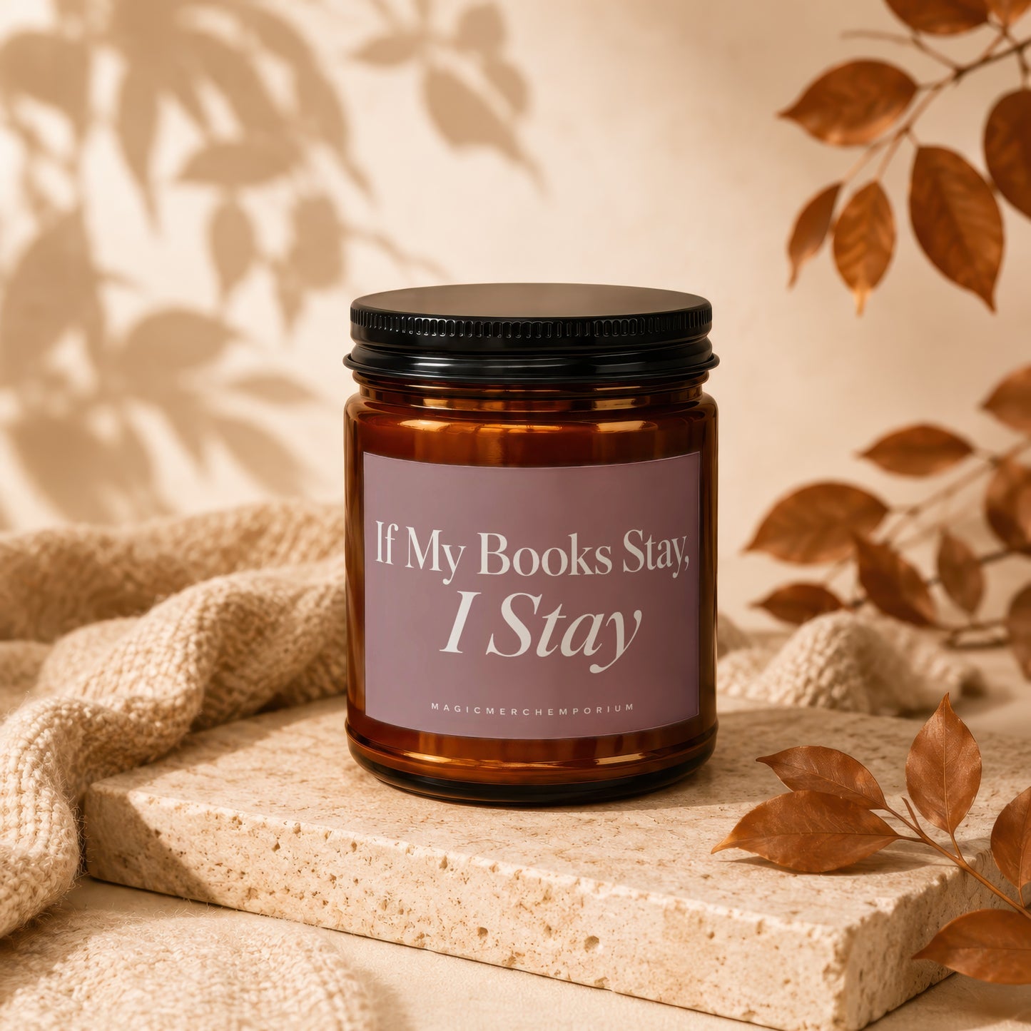 Amber jar candle with purple label reading "If My Books Stay, I Stay."