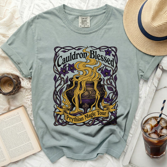 Light green t-shirt with "Cauldron Blessed Prythian Magic Tour" graphic.