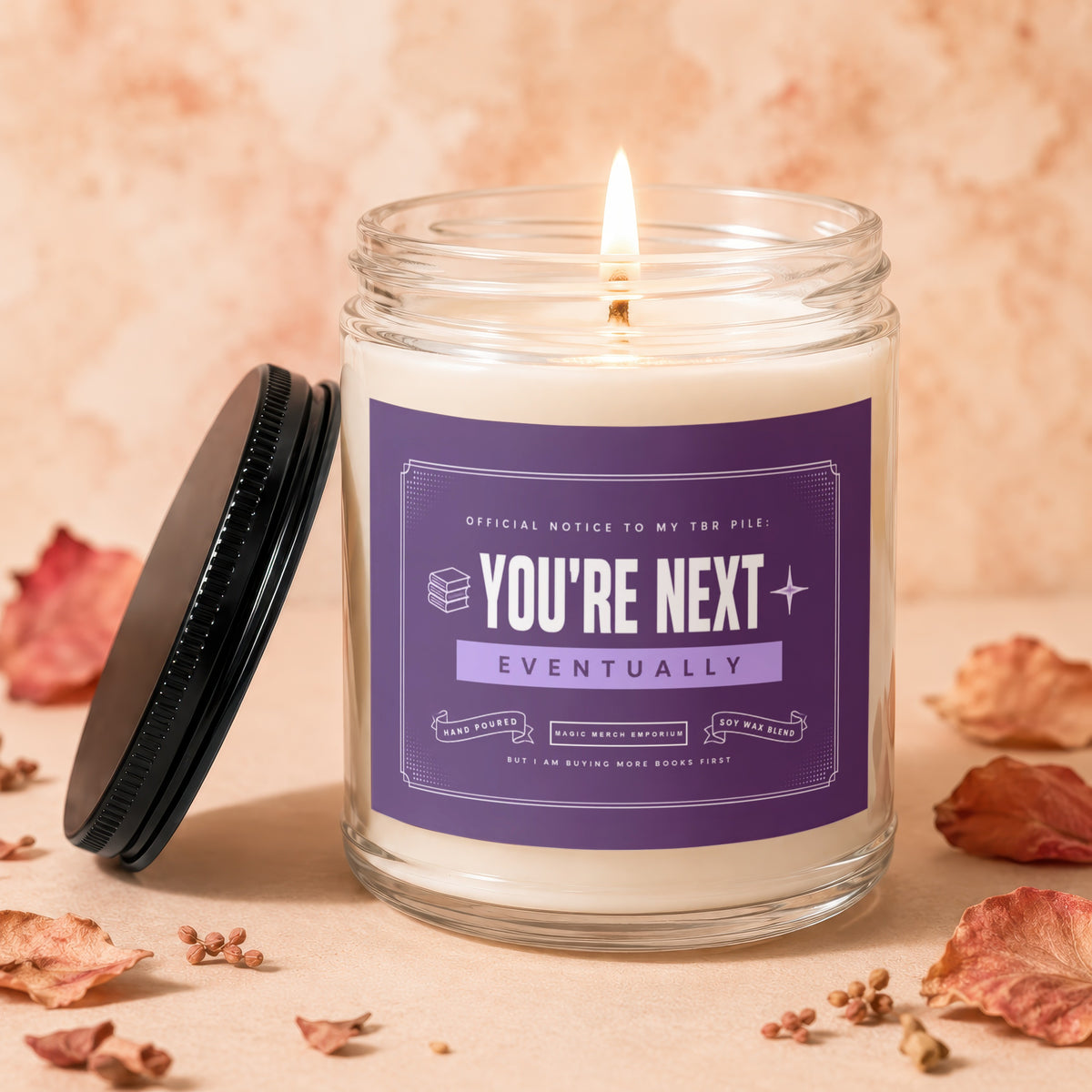 Jar candle with purple label reading "You're Next Eventually."