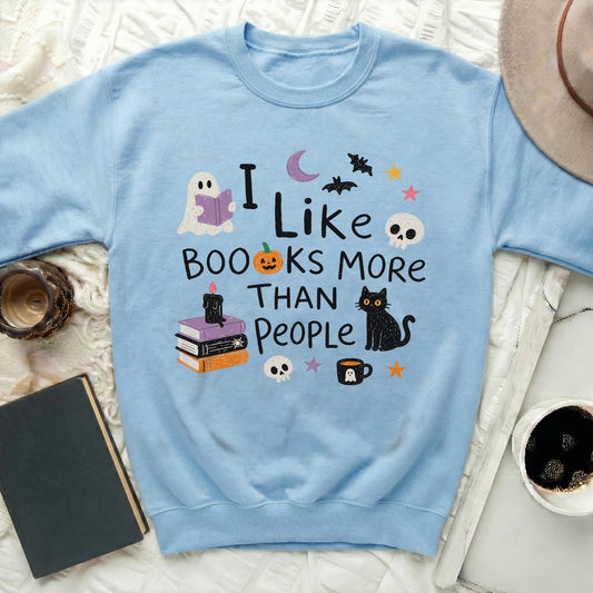 Light blue sweatshirt with "I like books more than people" Halloween graphic.
