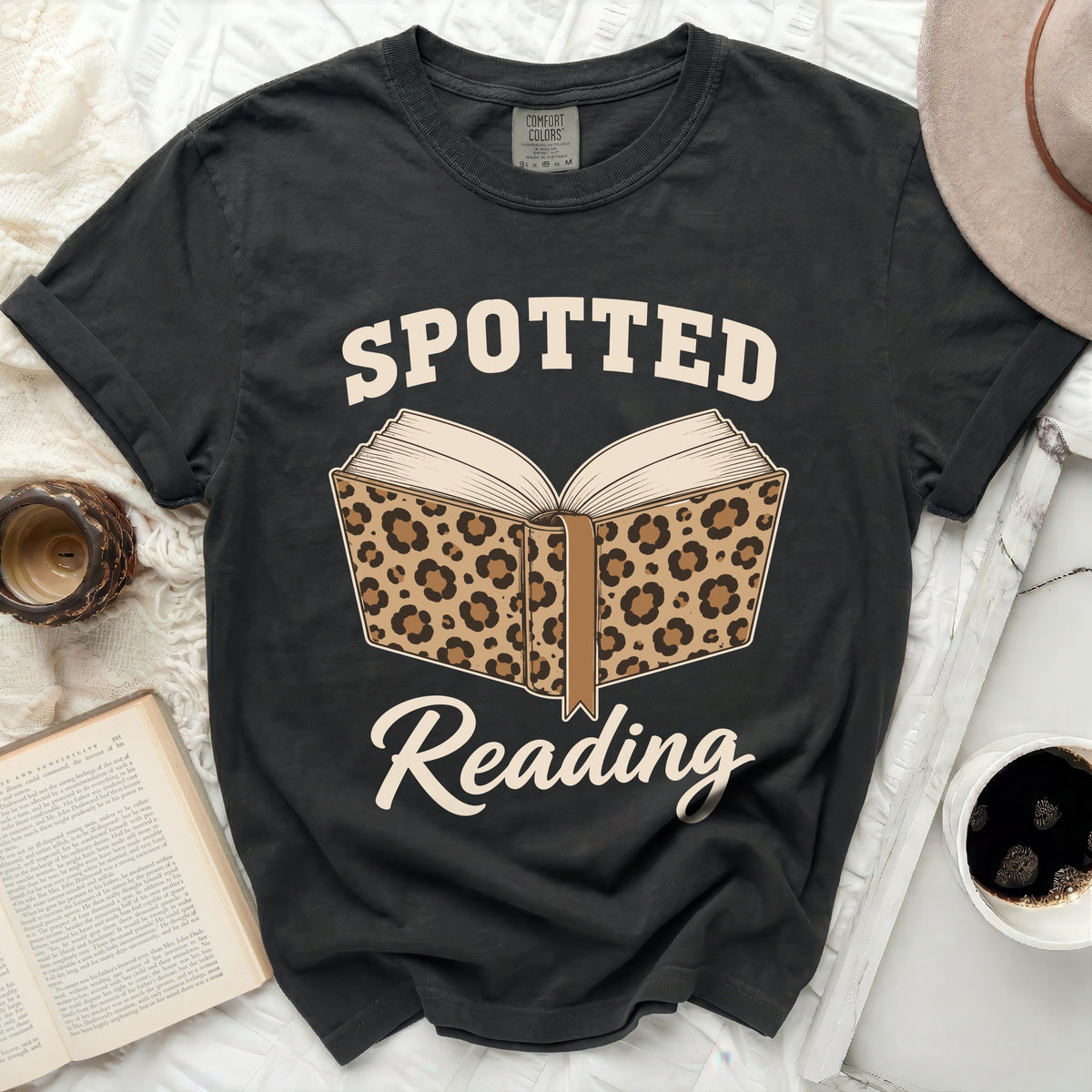 Black t-shirt with "Spotted Reading" and leopard print book graphic.
