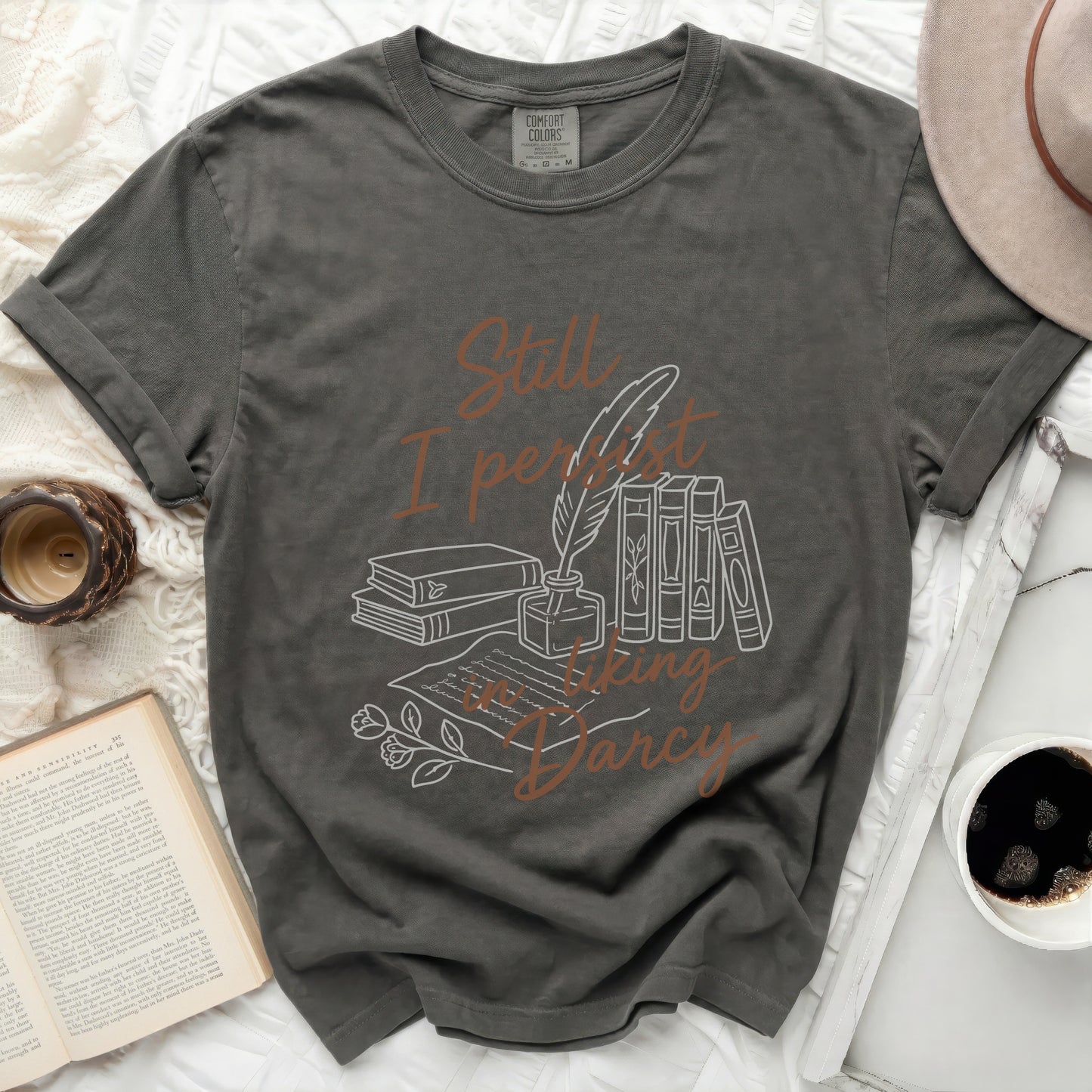Graphic t-shirt with literary design and text "Still I persist in liking Darcy."