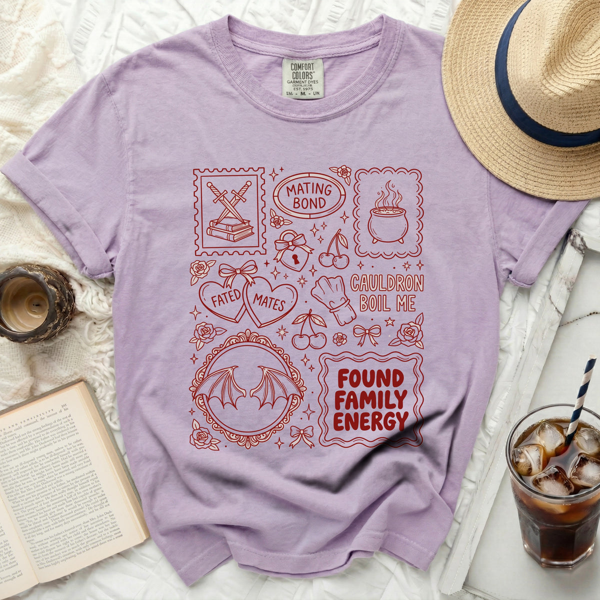 Purple t-shirt with red graphic design featuring text and occult-inspired illustrations.