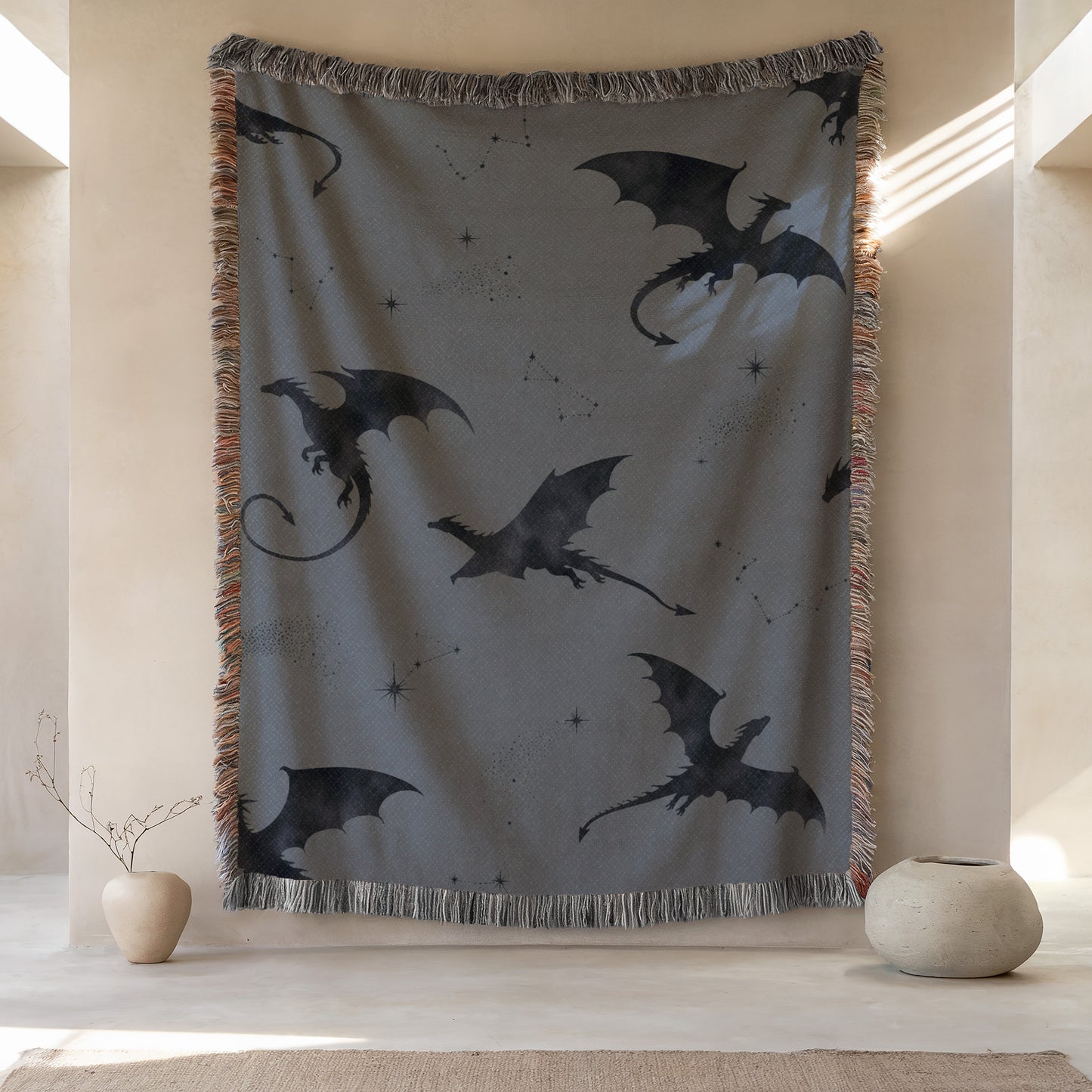 a large tapestry hanging on a wall, depicting a dragon design with stars and a starburst pattern. The tapestry is framed by a fringe border and is placed next to two small vases.