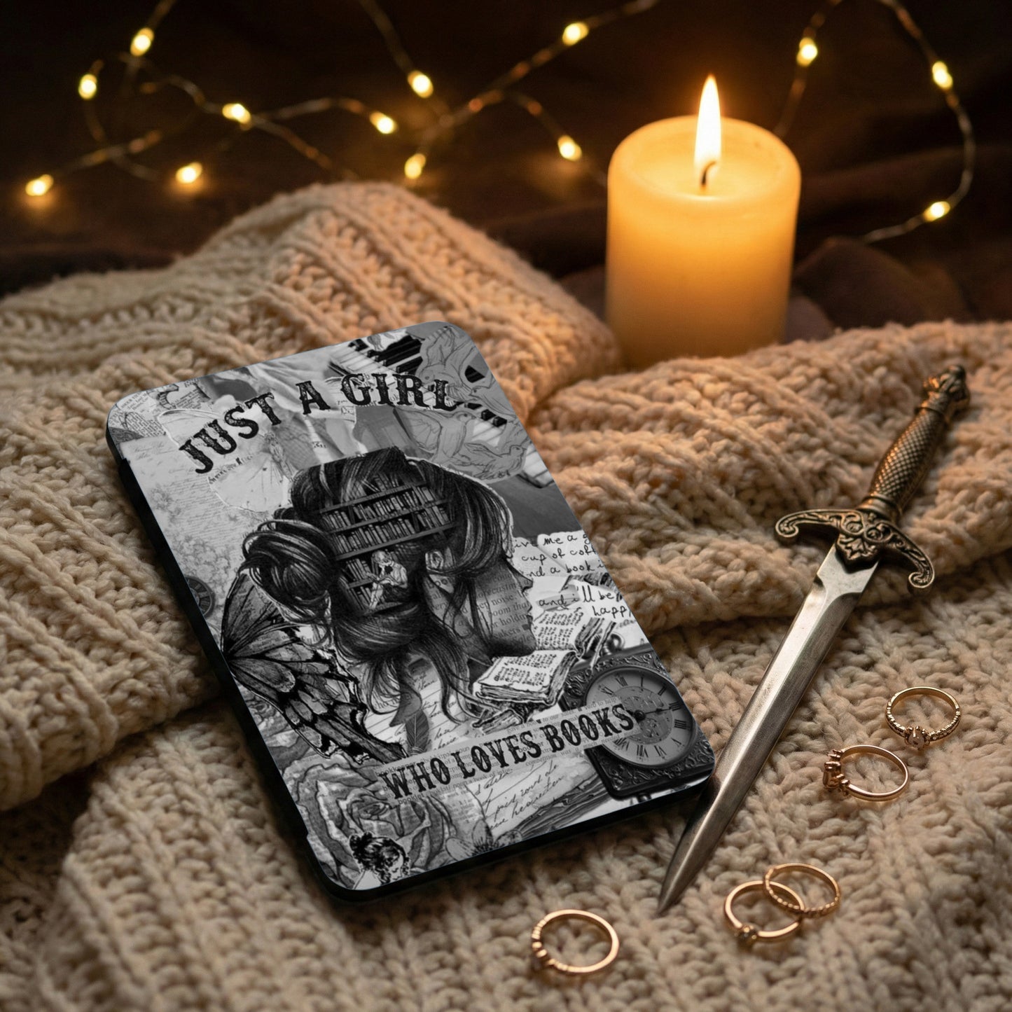 Black and white case with "Just a girl who loves books" design, by candlelight.