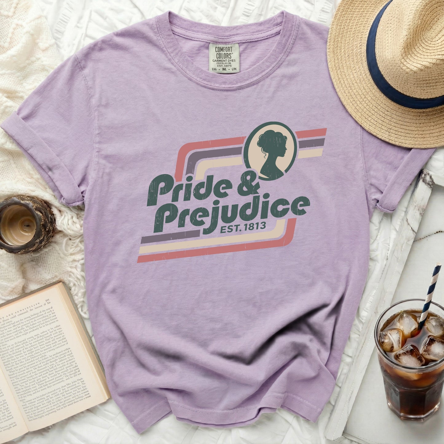 Purple Comfort Colors t-shirt with "Pride & Prejudice Est. 1813" graphic.