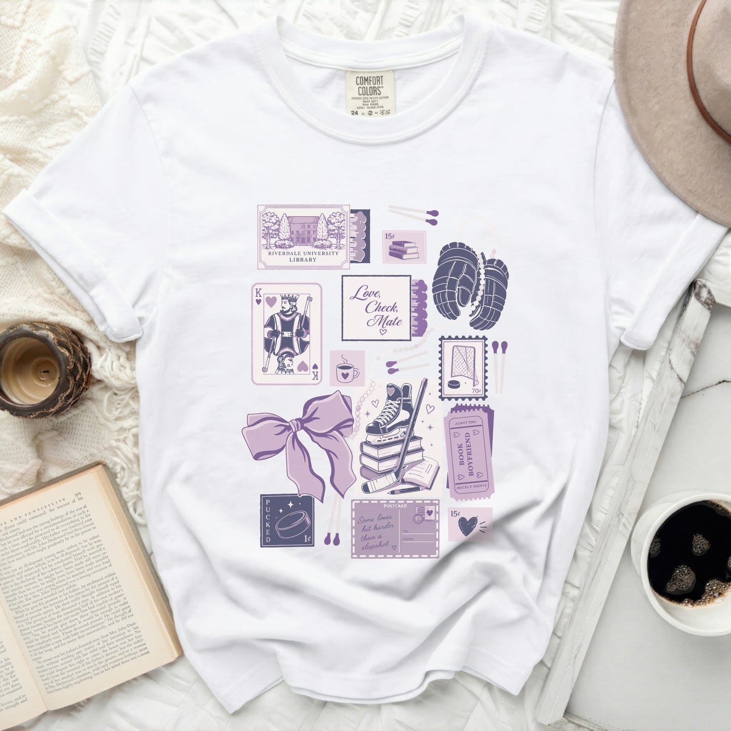 White t-shirt with "Love, Check Mate" text and ice skating and book-themed graphics.