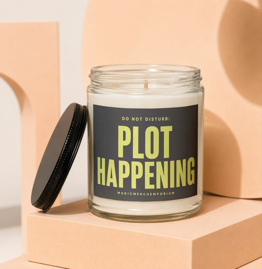 Glass jar candle with text "DO NOT DISTURB: PLOT HAPPENING" and "MAGICMERCHEPORIUM".