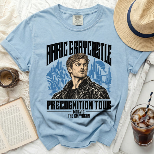Light blue t-shirt with graphic of man, cityscape, and text "ARIC GRAYCASTLE PRECOGNITION TOUR".