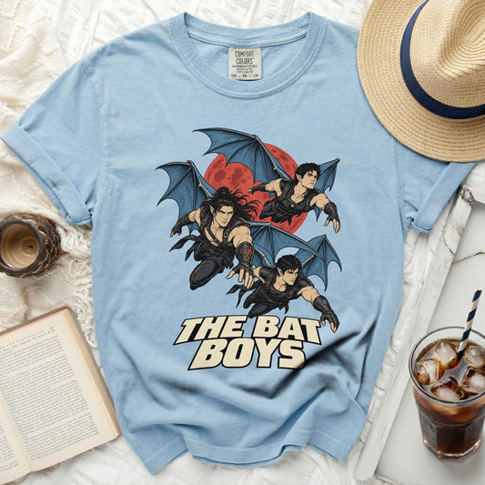 Light blue t-shirt with "The Bat Boys" text and winged figures graphic.