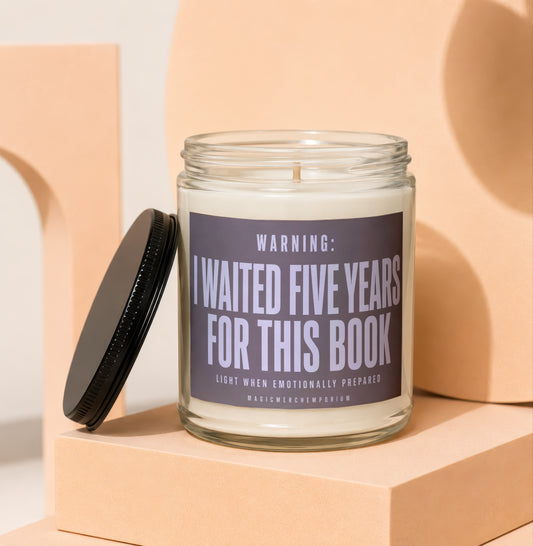 Glass candle with black lid and label reading "Warning: I Waited Five Years For This Book".