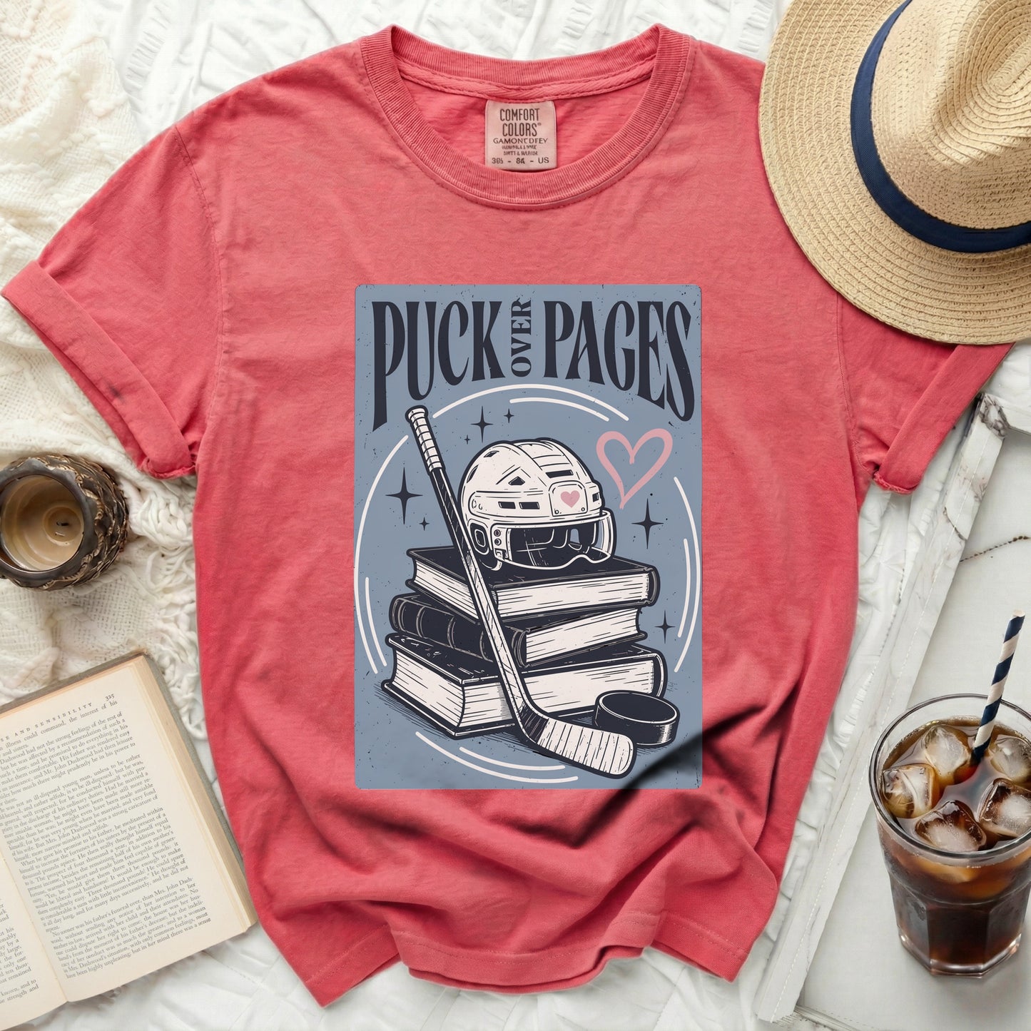 T-shirt with hockey gear and "Puck Pages" text.