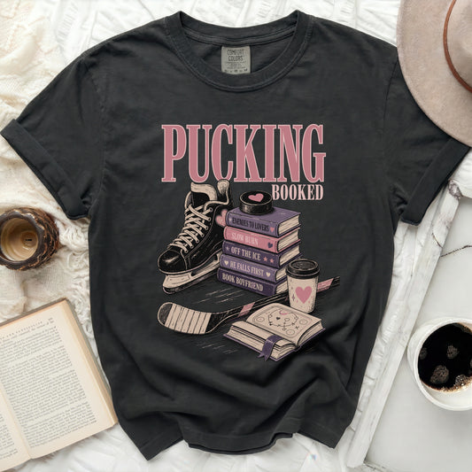 Black t-shirt with "Pucking Booked" and book-themed hockey illustrations.