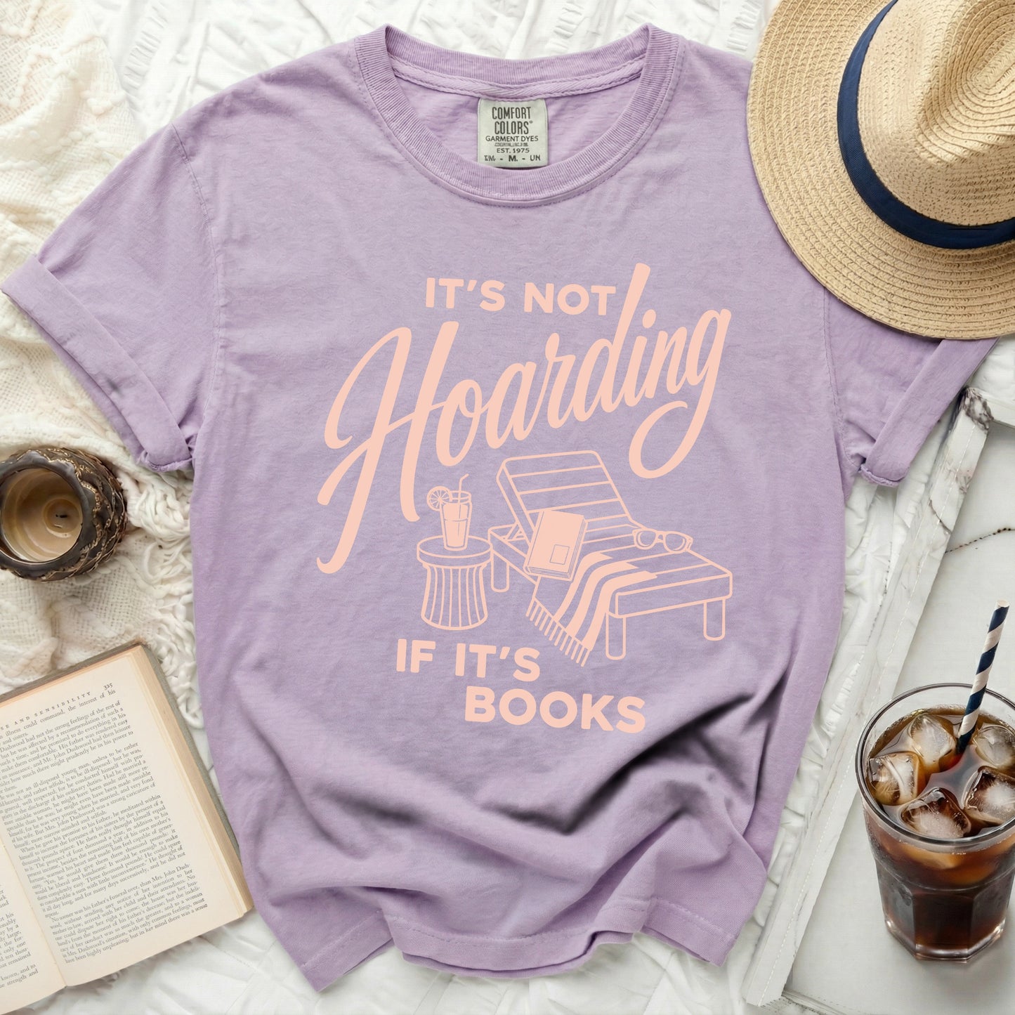 Purple t-shirt with "It's not hoarding if it's books" text.
