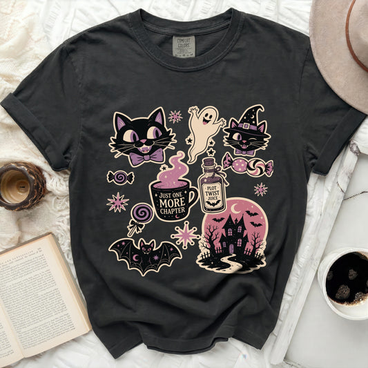 Dark gray t-shirt with Halloween graphic designs: cats, ghost, haunted house, and text.