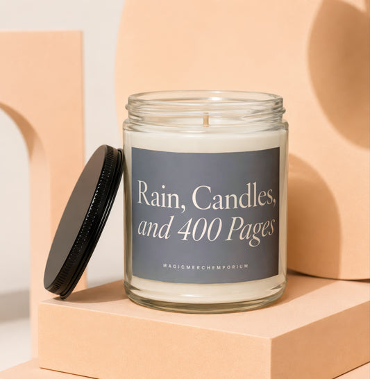 Glass candle with gray label reading "Rain, Candles, and 400 Pages"