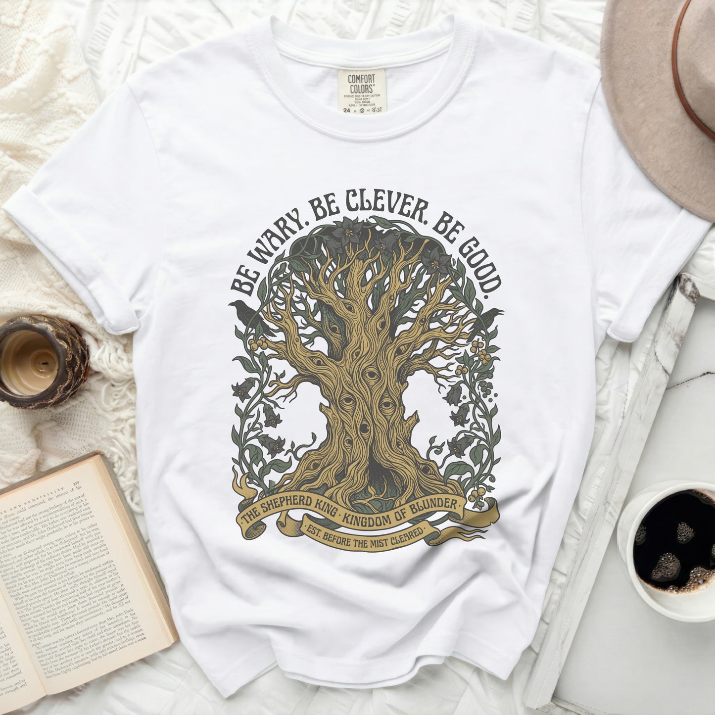 White t-shirt with a tree graphic and "Be Wary. Be Clever. Be Good." text.