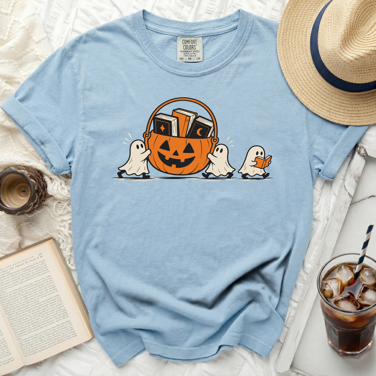 Light blue t-shirt with ghosts carrying a pumpkin basket of books.