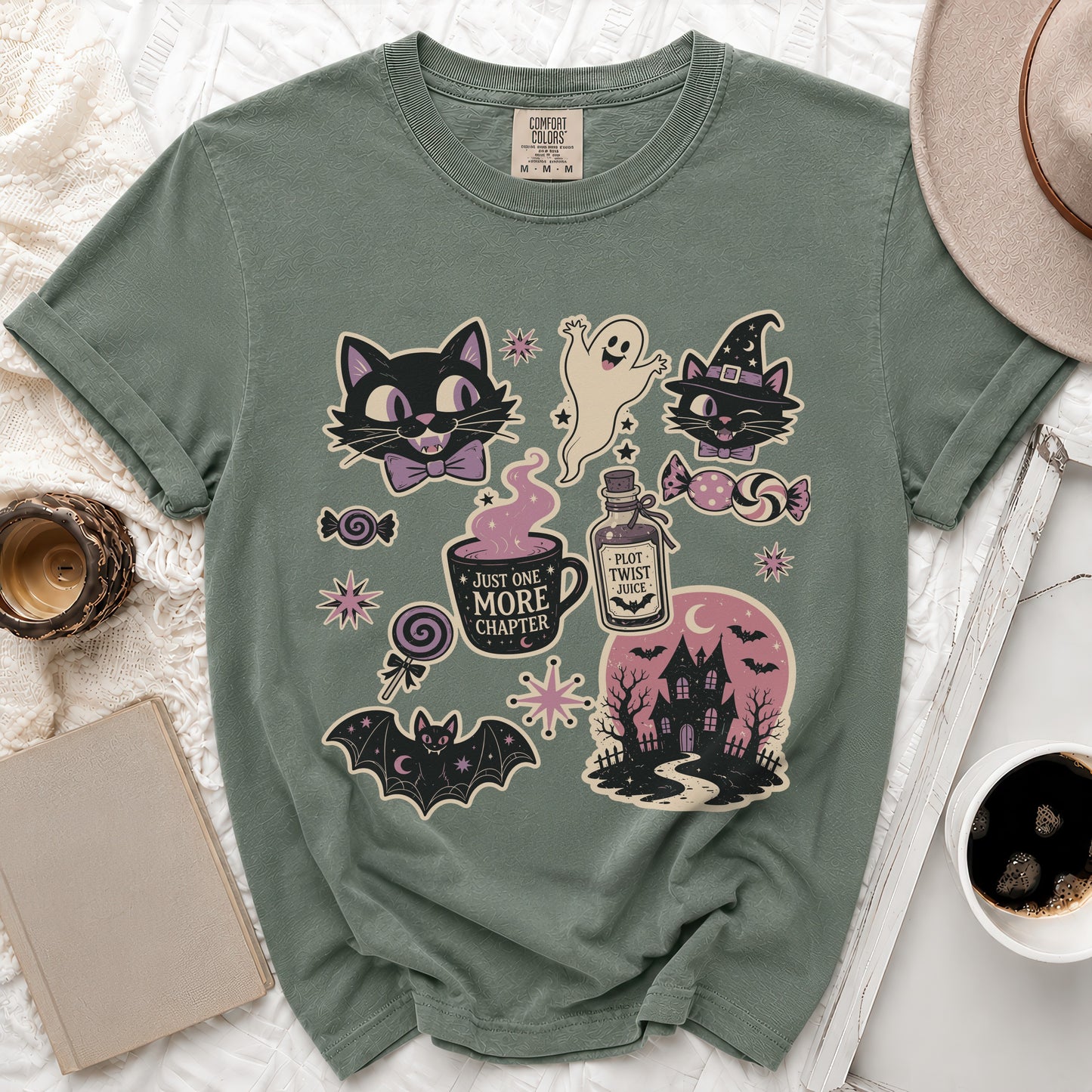 T-shirt with Halloween-themed graphics including cats, ghost, haunted house, and potion.