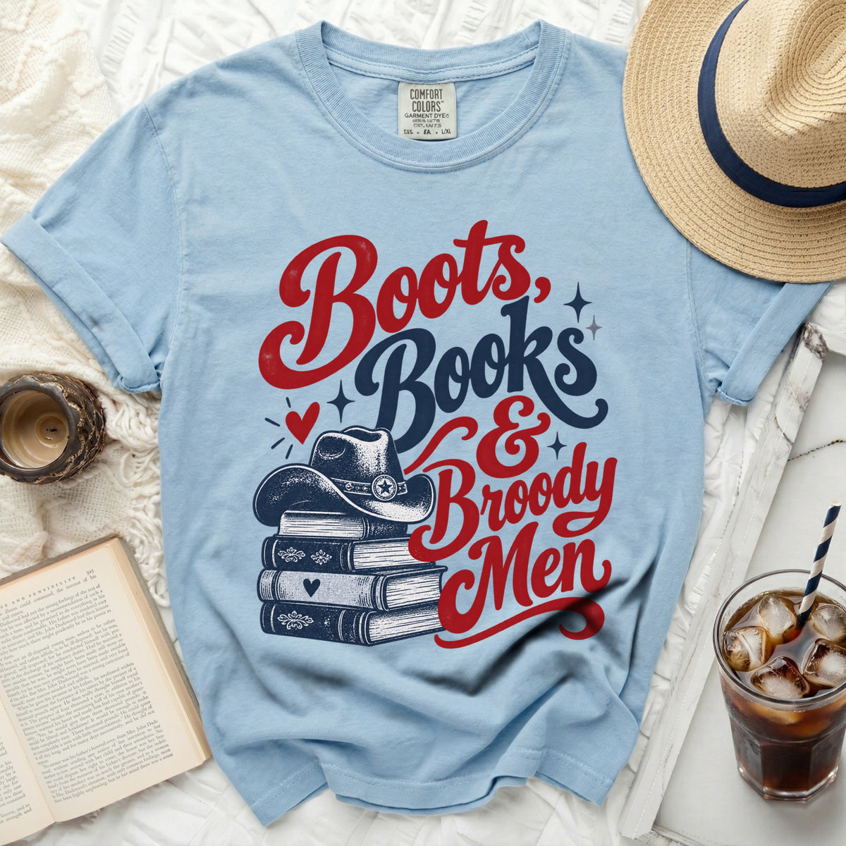 Light blue t-shirt with "Boots, Books & Broody Men" graphic and cowboy hat.