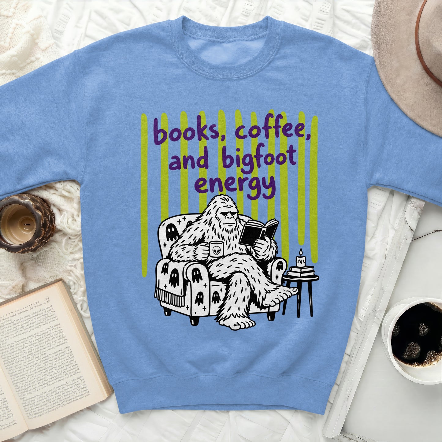 Bigfoot reading a book and drinking coffee with "books, coffee, and bigfoot energy" text.