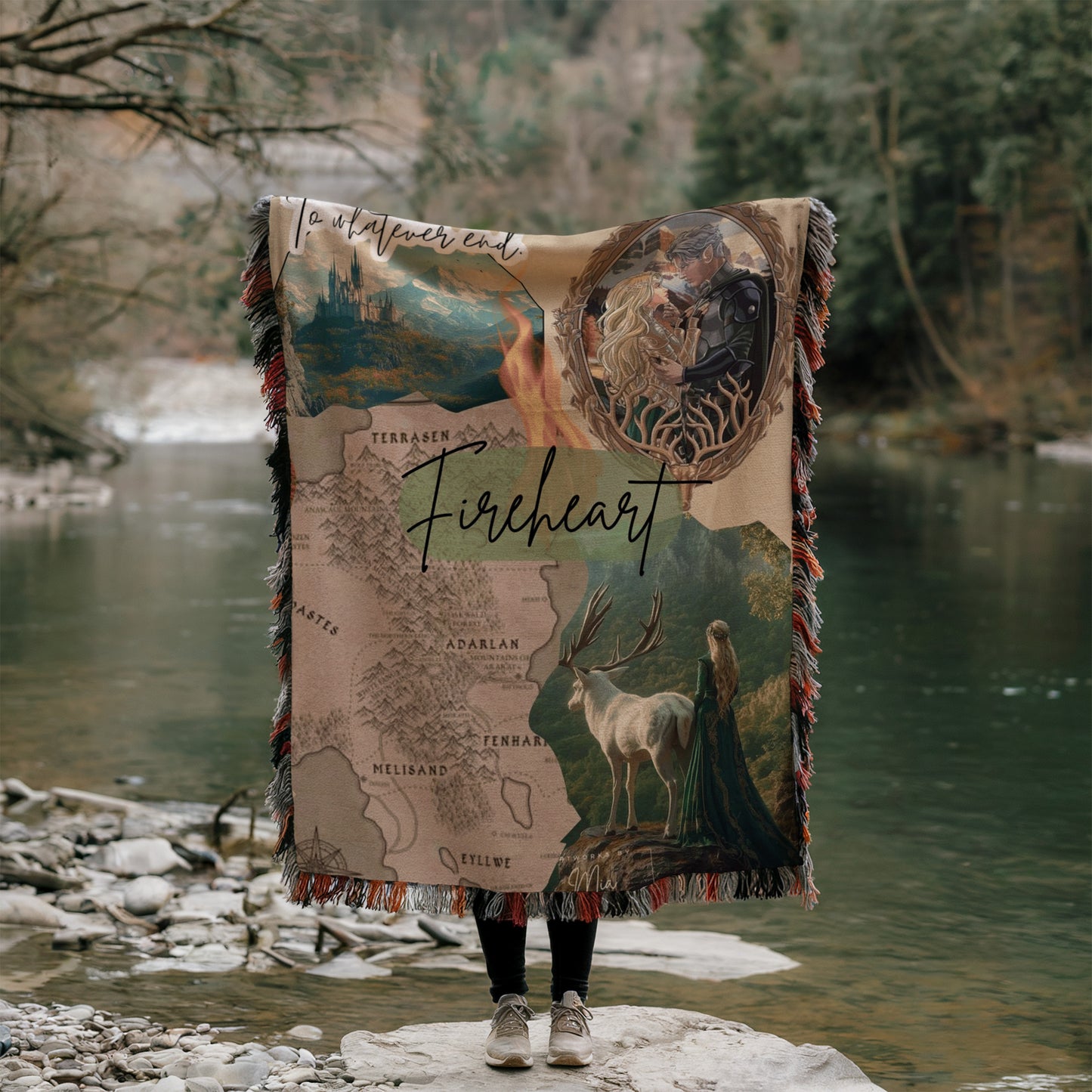 A person is standing on a rock, holding a large blanket with a map and various images of animals, including a deer and a castle, against a backdrop of a river and trees.