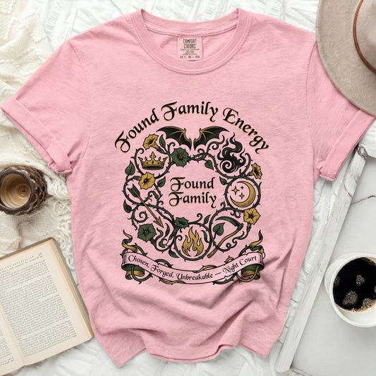 Pink t-shirt with "Found Family Energy" and wreath design.