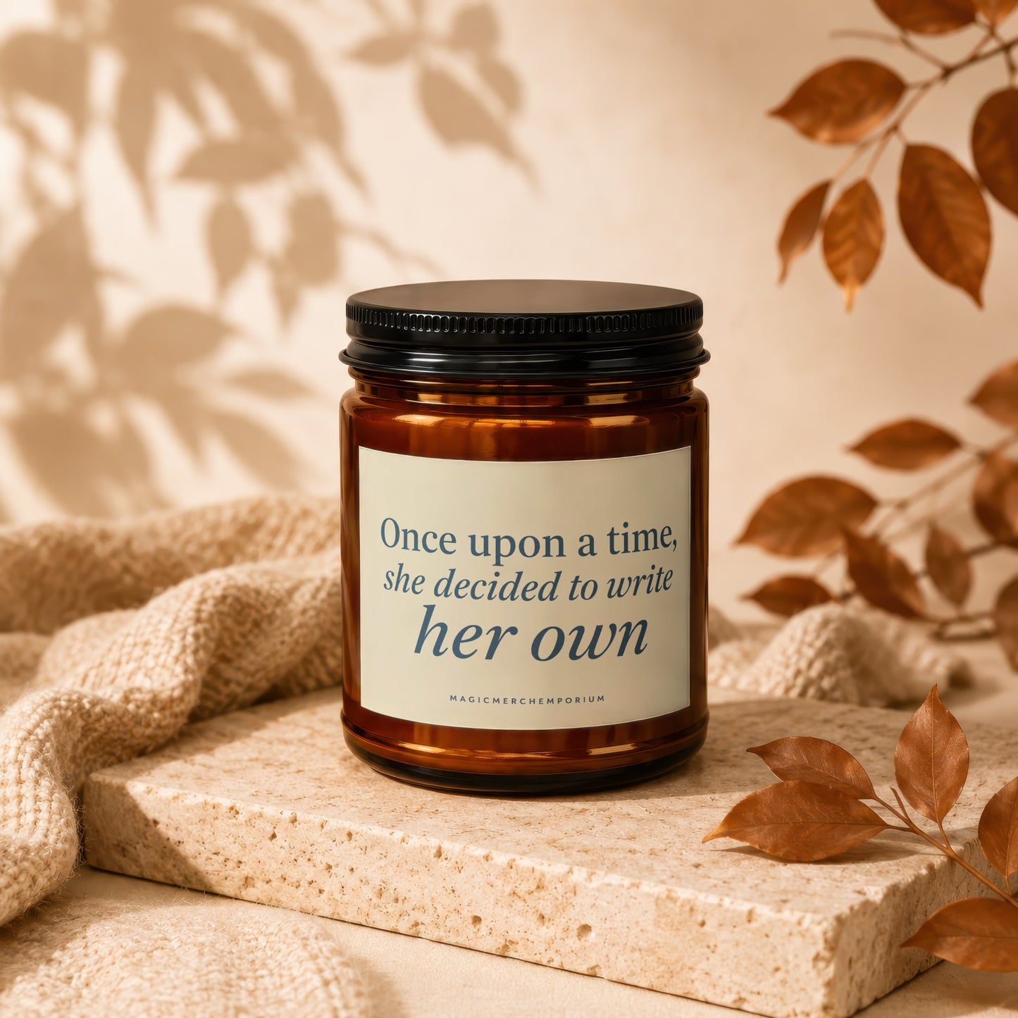 Amber candle with black lid displaying quote "Once upon a time, she decided to write her own".